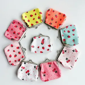 Detailed flat lay of mini clasp purses with fruit prints and glitter texture finish