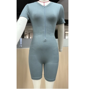 Detail of ribbed seamless bodysuit featuring front zipper and slate blue knitted fabric