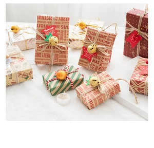 Detailed Christmas gift wrap set with printed paper, golden bells and jute twine