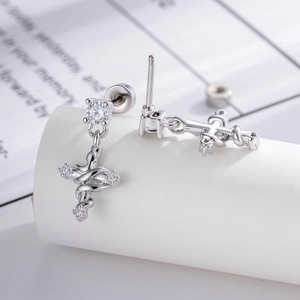 Silver snake wrap cross earrings with micro-pave cubic zirconia crystals for a gothic style