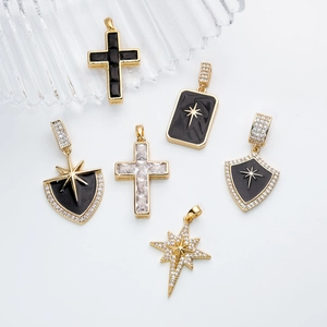 Retro cross and shield pendants in gold plating with black enamel and zircon details