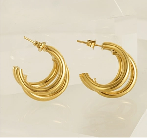 Detailed view of 18K gold plated multi-layer hoop earrings with triple stacked ring design