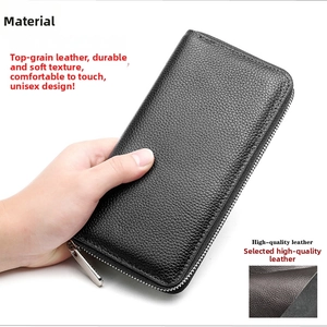 Close-up of black genuine leather wallet with lychee grain texture and silver zipper