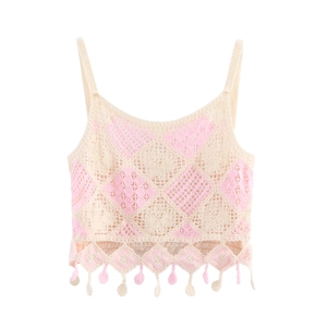 Close-up of beige crochet knit camisole with diamond patterns and decorative tassel hem