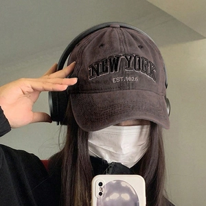 Detail of vintage washed baseball cap with New York 3D embroidery and worn texture