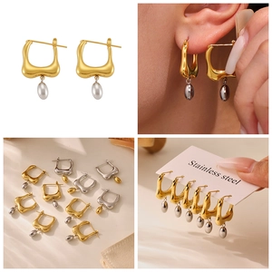 Macro detail of irregular geometric stainless steel earrings with oval drop pendant