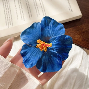 Macro shot of a blue frangipani flower clip with yellow stamens on an artistic background