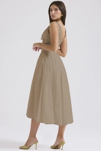 Detailed side view of khaki sleeveless midi dress with elegant pleated hem and matte fabric