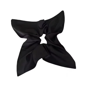Elegant black satin scrunchie with silk bow design on white background for women