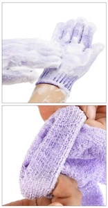 Detail of purple exfoliating gloves showing knitted texture and rich foam lather