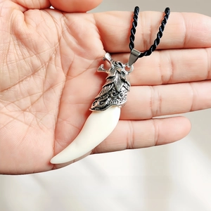 Close-up of wolf tooth pendant with 6.7cm length and 45cm black cord necklace detail