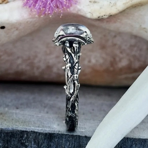 Macro detail of silver vintage branch ring with round clear crystal gemstone inlay