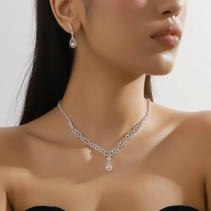 Exquisite necklace and earrings set featuring sparkling pear-shaped champagne stones