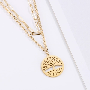 Detail of gold double-layer necklace with paperclip chain and tree of life pendant