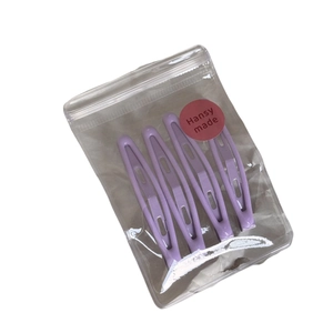 Set of four glossy purple hollow-out hair clips in minimalist candy-colored style