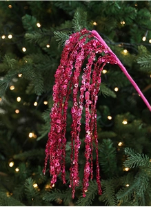 Detail of shimmering magenta sequin Christmas spray pick with hanging tassel texture
