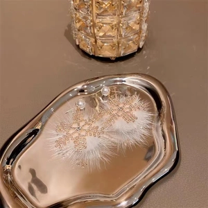 Sparkling snowflake earrings with gold frame, white pearls and soft plush elements