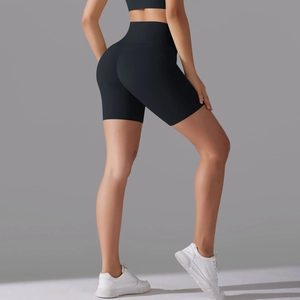 Detail view of high waisted black fitness shorts with bum lifting seam on a female model