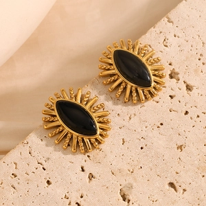Detail of 18K gold-plated earring with black agate marquise stone and sunburst design