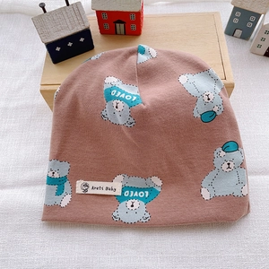 Detail of baby cotton knit beanie in bean paste red with cute cartoon bear print