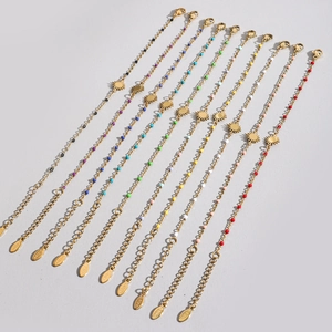 Detail of colorful beads and sun charms on gold stainless steel bracelets collection