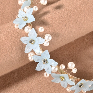 Detail of floral faux pearl headband with light blue matte flowers and gold wire