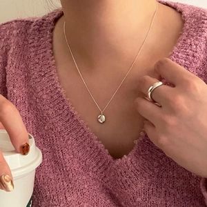 Minimalist 925 sterling silver necklace and ring set shown in a cozy lifestyle setting