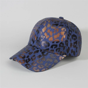 Detail of blue denim baseball cap with leopard print and vintage bronze texture