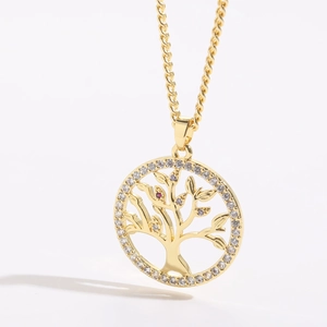 Detail of 14K gold tree of life pendant featuring white zircon and colored crystals