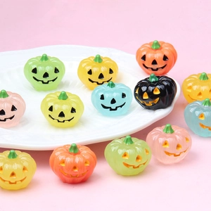 Close-up of colorful luminous resin pumpkin ornaments for Halloween DIY decor