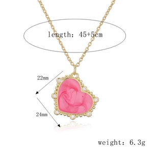 Detailed view of pink heart pendant with gold chain and dimensions 22mm by 24mm