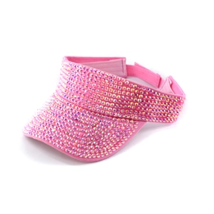 Detail of pink fabric visor with meticulously hand-set colorful sparkling rhinestones