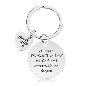 Close-up of engraved silver metal teacher appreciation keychain with thank you heart pendant