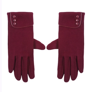 Close-up of wine red winter fleece gloves with suede texture and three button details