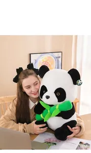 Detailed shot of a soft panda plush toy held by a person in a cozy indoor setting