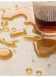 Detail showing waterproof performance of beige textured carpet with water droplets