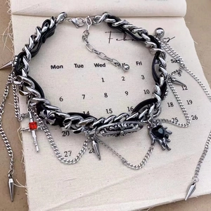 Detailed view of Y2K layered necklace with cross and heart pendants on vintage calendar