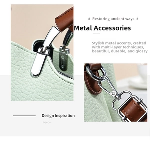 Detail of silver-tone hardware and litchi-grain leather on the mint green bag