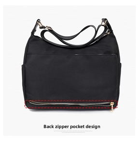 Close-up of the anti-theft back zipper pocket on this black nylon crossbody bag