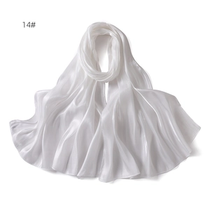 Detailed view of white plain satin shawl with silky texture and elegant shimmering finish
