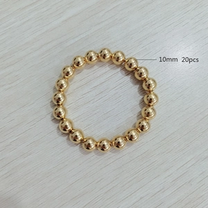 Top view of 10mm golden stainless steel beaded bracelet with 20 pieces on wood