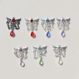 Detailed flat lay of angel wing tassel pendants with colorful rhinestones in seven colors