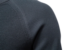 Detail shot of the shoulder seam and knit texture on this navy blue crewneck sweater