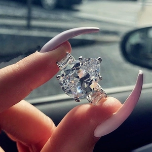 Macro shot of a luxury teardrop-cut zircon ring with elegant rectangular side stones