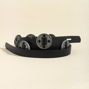Detail of black leather belt featuring vintage circular metal studs and dark gemstones