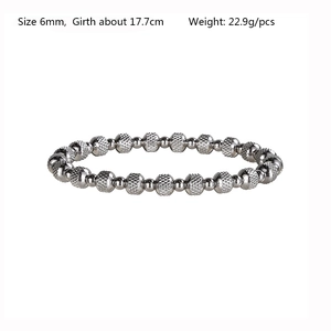Detail view of 6mm silver stainless steel beaded bracelet with textured barrel beads