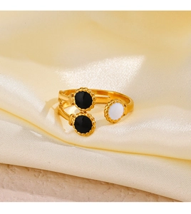 Detailed macro view of retro gold plated adjustable ring with black and white enamel discs