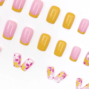 Floral French press-on nails with sweet pink base and yellow tips for women