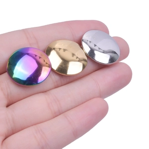 Close-up of three polished 304 stainless steel dome earrings in gold, silver and rainbow