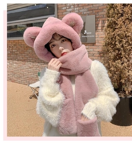 Outdoor street photo of a pink plush bear ear hat and scarf set for winter warmth